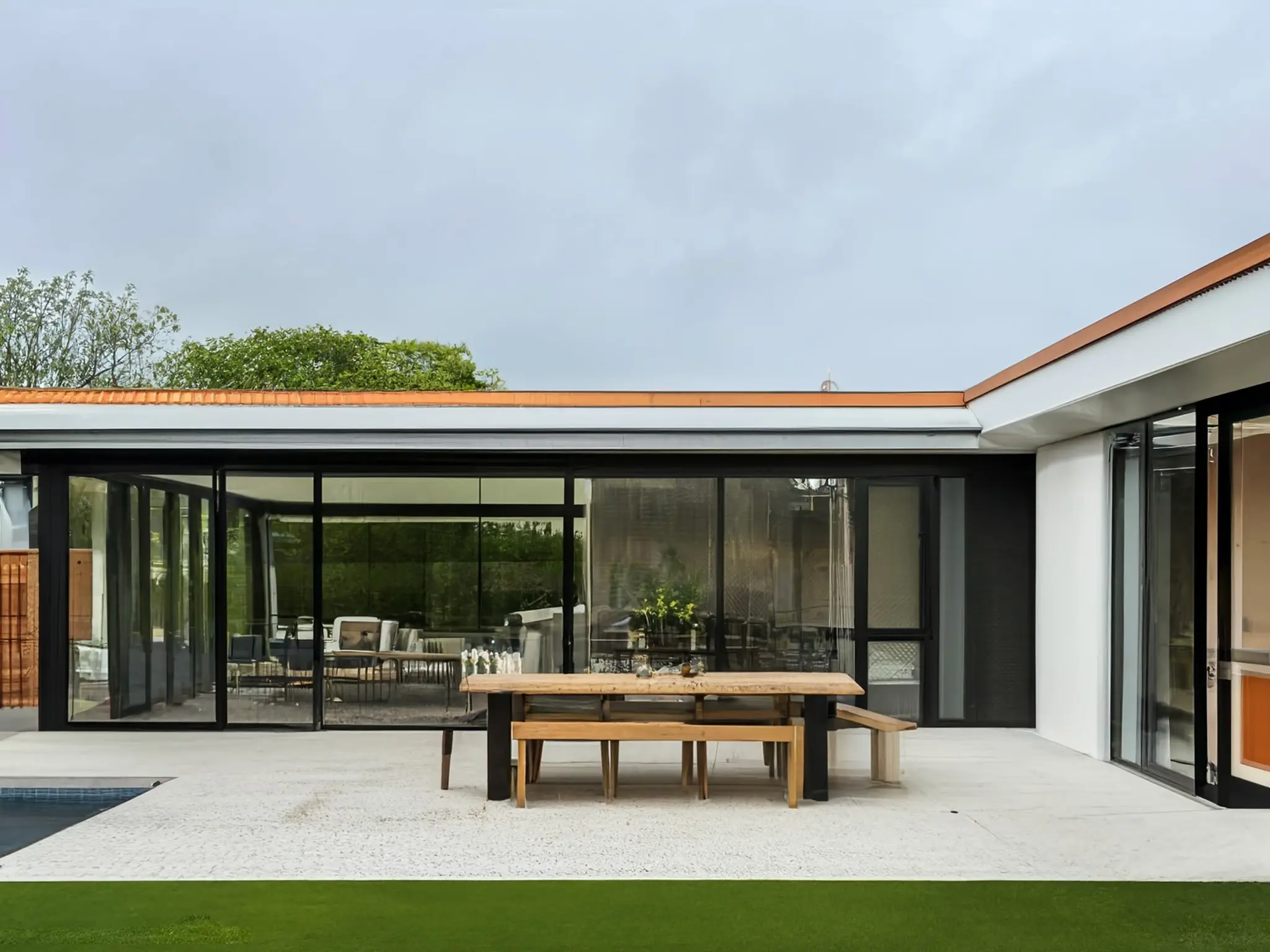 Modern Exterior Remodel Featuring Glass Extension and Stylish Deck
