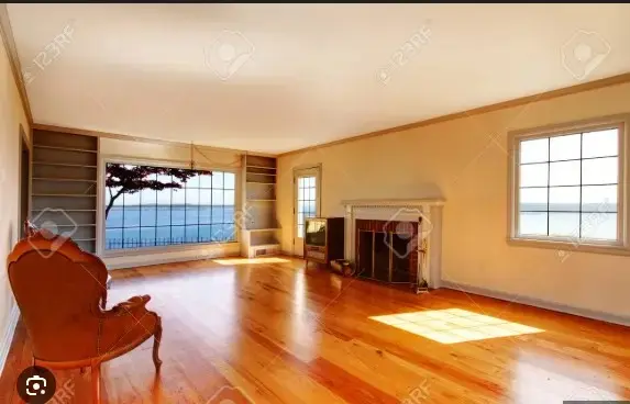 <p>Create a spacious 400-square-foot living room with a modern aesthetic using a neutral color palette composed of white, gray, and light wood tones. Display a comfortable gray sectional sofa facing a sleek, minimalist modern fireplace. Place a large, plush area rug underneath a multifunctional coffee table with storage enhancements. On one side of the room, design a floor-to-ceiling bookshelf with integrated LED lighting. A large sliding glass door should lead to a balcony that reveals a beautiful view of the sea. Hang modern abstract art pieces on the walls and integrate smart home amenities such as automated blinds and smart lighting. Incorporate large windows to allow a flood of natural light into the room and add indoor plants to introduce a pop of green color to the aesthetic.</p>