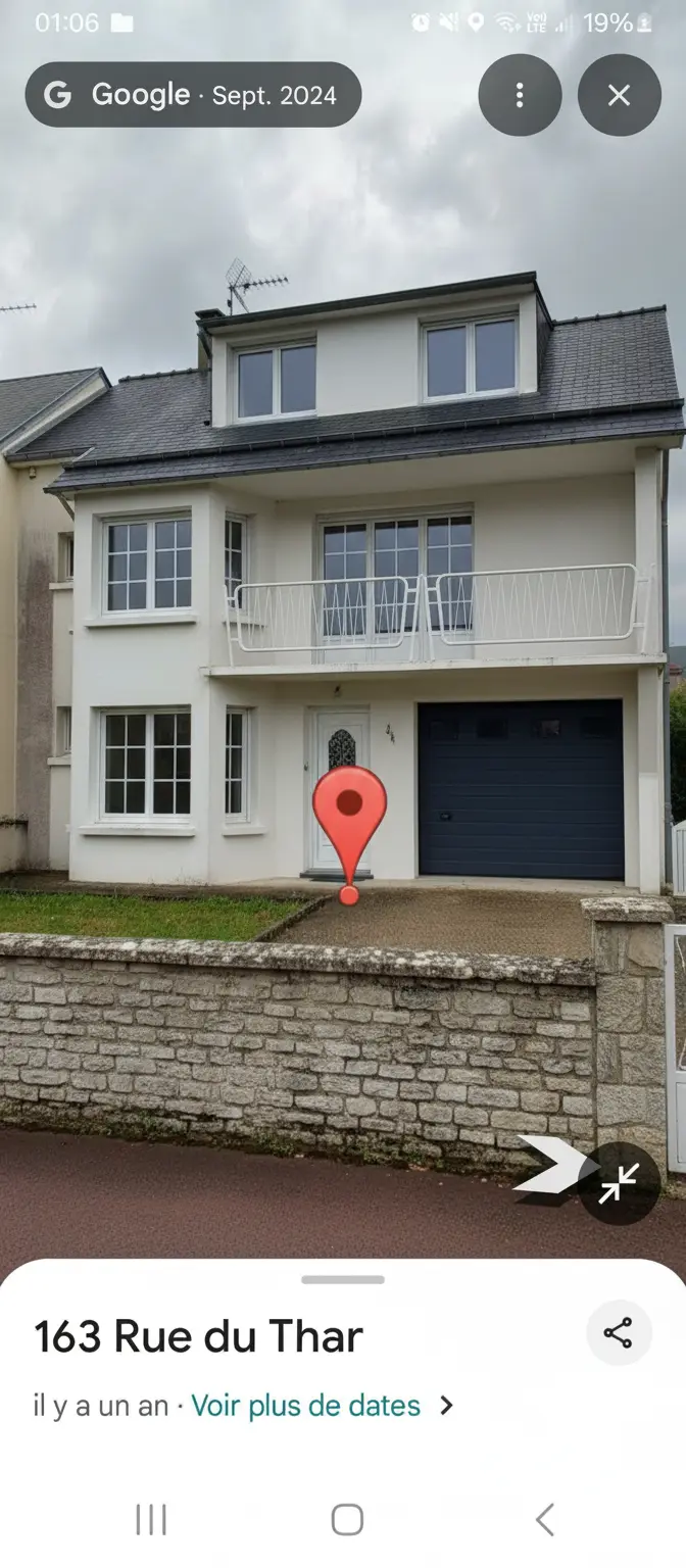 Exterior Renovation: Traditional French Home with Slate Roof, Stone Wall, and Bay Window